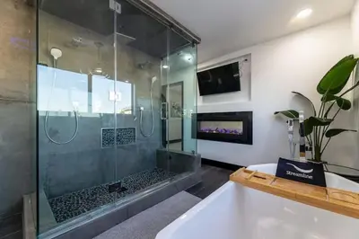 a bathroom with a shower and a bath tub at Modern San Pedro Home, Sleeps 12, Hot Tub, Fire Place, Private Parking in San Pedro
