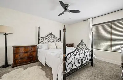 a bedroom with a bed and a ceiling fan at Elegant Hollywood Retreat - Spacious 2BR 2BA Condo with Resort-Style Amenities in Los Angeles