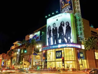 a building with a billboard of a group of people on it at Elegant Hollywood Retreat - Spacious 2BR 2BA Condo with Resort-Style Amenities in Los Angeles