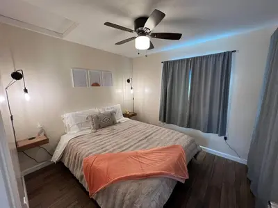 a bedroom with a bed and a ceiling fan at La Casita de Whittier, Private Unit w/patio area, Disney, Biola, Knotts in Whittier