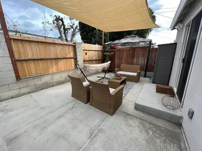 a patio with a table and chairs and a fence at La Casita de Whittier, Private Unit w/patio area, Disney, Biola, Knotts in Whittier