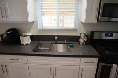 a kitchen counter with a sink and a microwave at The Blue Lake Cabin! 1 min Walk to SnowPlay! in Big Bear City