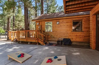 a cabin with two jump mats in front of it at The RobinHood Retreat! A 1 min Walk to SnowPlay! in Big Bear City
