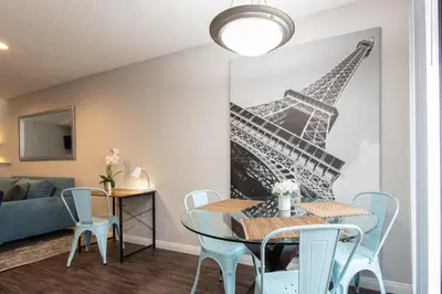 a dining room with a table and a mural of the eiffel tower at Skyline Terrace Executive Jr One Bedroom with Balcony and Pool in Los Angeles