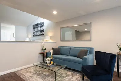 a living room with a blue couch and a chair at Skyline Terrace Executive Jr One Bedroom with Balcony and Pool in Los Angeles