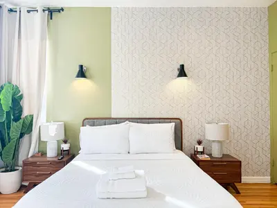 a bedroom with a large white bed with two lamps at Stylish Residence in Los Angeles - OL-WH in Los Angeles