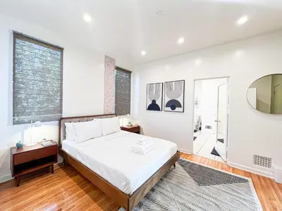 a bedroom with a bed and a large window at Stylish Residence in Los Angeles - OL-WH in Los Angeles