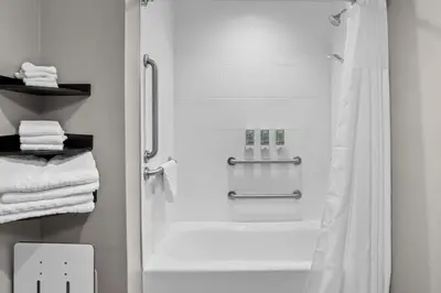 a bathroom with a shower with a shower curtain at Best Western San Bernardino Hotel in San Bernardino