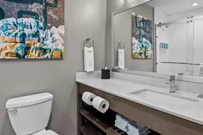 a bathroom with a sink and a toilet and a mirror at Best Western San Bernardino Hotel in San Bernardino