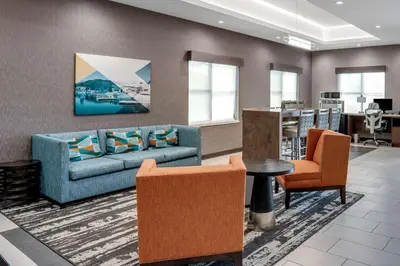 a living room with a couch and a table and chairs at Best Western San Bernardino Hotel in San Bernardino