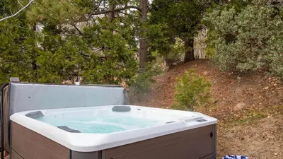 a bath tub sitting in front of some trees at North Bay by AvantStay Chic Retreat w Peloton in Blue Jay