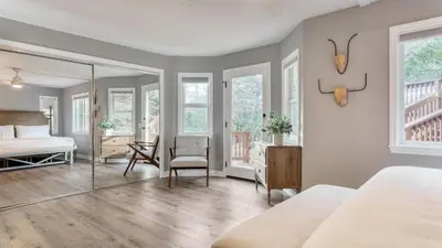 a bedroom with a bed and a mirror at North Bay by AvantStay Chic Retreat w Peloton in Blue Jay