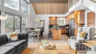 a living room with a couch and a table at North Bay by AvantStay Chic Retreat w Peloton in Blue Jay