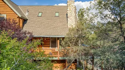 a house with a chimney and a deck at Tanglewood by AvantStay 10mins to Bear Mountain Contemporary Hillside Cabin in Big Bear Lake