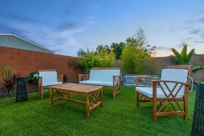 a group of chairs and a table on a lawn at Gameroom Sofi Stadium Forum Backyard BBQ in Hawthorne