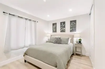 a white bedroom with a bed and a window at Gameroom Sofi Stadium Forum Backyard BBQ in Hawthorne