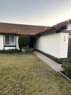 a house with a yard with a driveway at Cozy Family Home - 20 Mins from Disneyland in Placentia