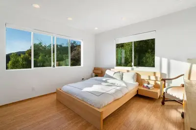 a bedroom with a bed and two windows at Malibu Secluded Escape Ocean View Zen House in Malibu