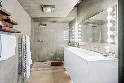 a bathroom with a white sink and a mirror at Malibu Glass House: Architectural w 180deg Views in Malibu