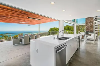 an open kitchen with a view of the ocean at Malibu Glass House: Architectural w 180deg Views in Malibu