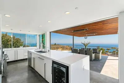 a kitchen with a view of the ocean at Malibu Glass House: Architectural w 180deg Views in Malibu