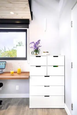 a kitchen with white cabinets and a window at Bright European Loft In Venice Beach in Los Angeles