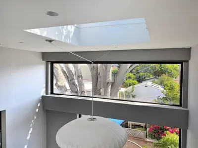 a large window in a house with a white lamp at Bright European Loft In Venice Beach in Los Angeles