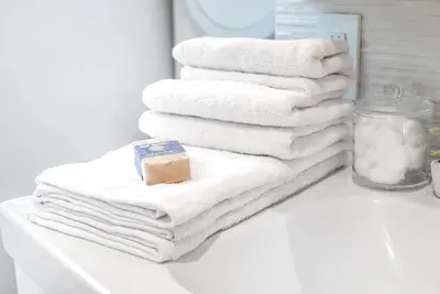 a pile of towels sitting on a bathroom counter at Bright European Loft In Venice Beach in Los Angeles