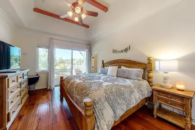 a bedroom with a bed and a television and a dresser at Bayfront Beauty - Main in Lake Arrowhead