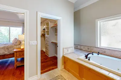 a bathroom with a bath tub and a window at Bayfront Beauty - Main in Lake Arrowhead
