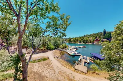 a group of boats docked at a dock on a lake at Bayfront Beauty - Main in Lake Arrowhead
