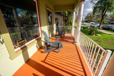 a porch with two chairs on a house at Downtown 3 bed newly renovated with amenities. in Bakersfield