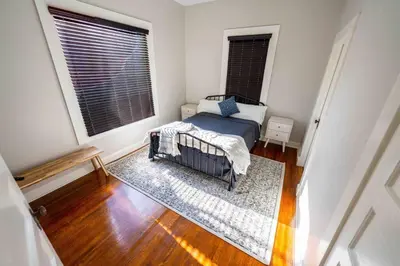 a bedroom with a bed and a large window at Downtown 3 bed newly renovated with amenities. in Bakersfield