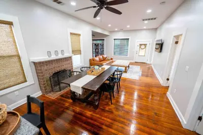 a living room with a table and a fireplace at Downtown 3 bed newly renovated with amenities. in Bakersfield