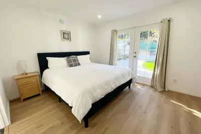 a bedroom with a large bed and a window at Modern 4 King Beds, Beautiful Large Backyard, Golf, WFH, Long Stays, WI-FI, FWY, 25 mins to Beach in Casa Conejo