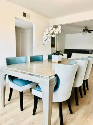 a dining room with a white table and chairs at Modern 4 King Beds, Beautiful Large Backyard, Golf, WFH, Long Stays, WI-FI, FWY, 25 mins to Beach in Casa Conejo