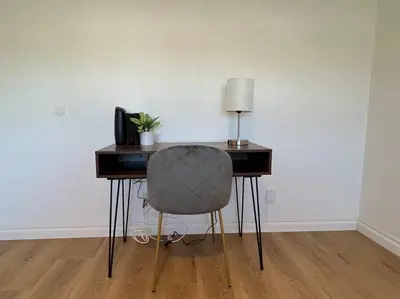 a desk with a chair and a lamp on it at Modern 4 King Beds, Beautiful Large Backyard, Golf, WFH, Long Stays, WI-FI, FWY, 25 mins to Beach in Casa Conejo
