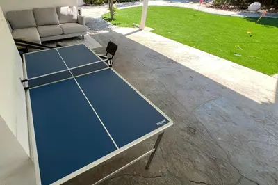 a ping pong table sitting on a patio at Modern 4 King Beds, Beautiful Large Backyard, Golf, WFH, Long Stays, WI-FI, FWY, 25 mins to Beach in Casa Conejo