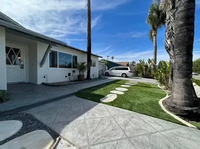 a house with a palm tree and a driveway at Modern 4 King Beds, Beautiful Large Backyard, Golf, WFH, Long Stays, WI-FI, FWY, 25 mins to Beach in Casa Conejo