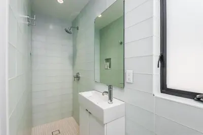 a bathroom with a sink and a mirror at Luxury Modern Designer Beach House on Sand w/ Pool in Ventura