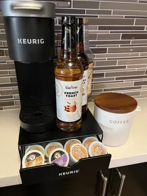 two bottles of beer and donuts on a counter at The Nest a Spacious 1 Bedroom Apartment with a Pool View in Los Angeles