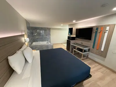 a bedroom with a large bed and a television at Rosemead Motel in Rosemead