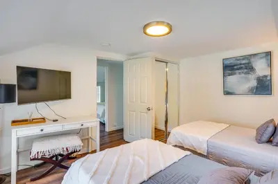 a bedroom with two beds and a desk with a television at Super Walkable! Historic Home in Dtwn Long Beach in Long Beach