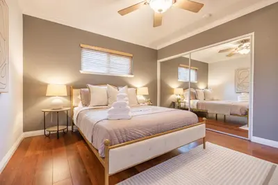a bedroom with a bed and a large mirror at #Marbella Lane - Charming 4BR Bungalo for Relaxing Retreat in Fullerton