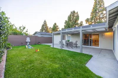 a backyard of a house with a lawn and chairs at #Marbella Lane - Charming 4BR Bungalo for Relaxing Retreat in Fullerton