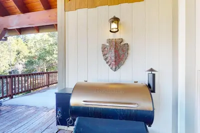 a grill on a porch with a heart on the wall at Arrowhead Haven in Lake Arrowhead
