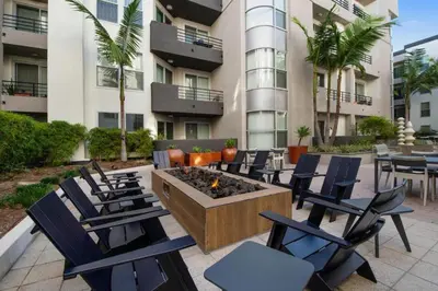 a patio with chairs and a fire pit in front of a building at Exclusive Suites in MDR-Venice with Pool, GYM & HotTub in Los Angeles