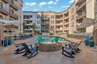 a patio with chairs and a fire pit in front of a building at Exclusive Suites in MDR-Venice with Pool, GYM & HotTub in Los Angeles