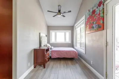 a bedroom with a bed and a ceiling fan at Amazing BBQ POOl home at center of LA\u7f8e\u5f0f\u56db\u623f\u5927\u5730\u6cf3\u6c60\u70e7\u70e4\u533a\u7f8e\u5c4b in Chino Hills