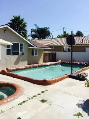 a swimming pool in front of a house at Amazing BBQ POOl home at center of LA\u7f8e\u5f0f\u56db\u623f\u5927\u5730\u6cf3\u6c60\u70e7\u70e4\u533a\u7f8e\u5c4b in Chino Hills